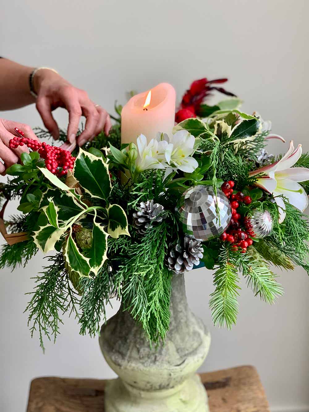 Creating Fresh Christmas wreath with candle